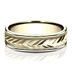 a wedding band with an intricate design in yellow gold