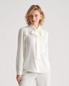 This polished blouse combines the best of both worlds. Wear the ties in a ladylike bow at the neck or leave them long and loose — whatever your mood calls for. Made of our bestselling premium mulberry silk, it has a hint of stretch for a flexible fit. Even better, it’s washable. As a bonus, silk fiber contains 18 kinds of amino acids that make it amazing for skin nourishment, hypo-allergenic, and naturally thermoregulating to help maintain body temperature. Navy Silk Skirt, Silk Fiber, Silky Shirt, Silk Cami, Lovely Tops, Quarter Zip Sweater, Tie Neck Blouse, Just Run, Beautiful Blouses