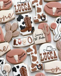 many decorated cookies are arranged in the shape of cowboy's and cowgirls