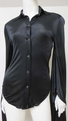 For Sale on 1stDibs - A fabulous black fine stretch silk shirt, top, blouse from Tom Ford for Gucci. It is semi fitted with a shirt collar, black mother of pearl Gucci inscribed Elegant Gucci Blouse For Evening, Elegant Gucci Blouse For Party, Elegant Gucci Party Blouse, Gucci Formal Button-up Blouse, Gucci Collared Blouse For Formal Occasions, Elegant Gucci Button-up Blouse, Gucci Formal Collared Blouse, Elegant Stretch Tops With Button Closure, Gucci Button-up Blouse For Formal Occasions