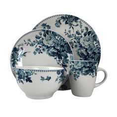 a blue and white dinner set with flowers on it