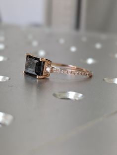 an engagement ring with a black diamond on it