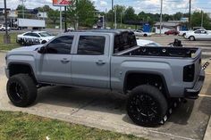 a silver truck parked in a parking lot