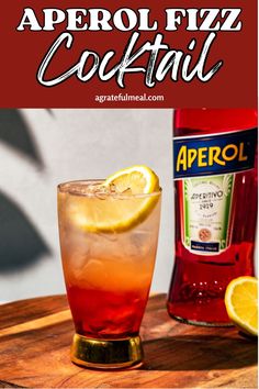 a close up of a drink on a table with the words aperol fizz cocktail