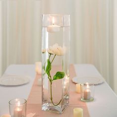 a vase filled with water and flowers on top of a table