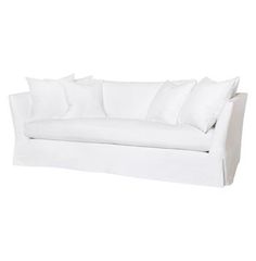 a white couch with several pillows on it's back and sides, against a white background