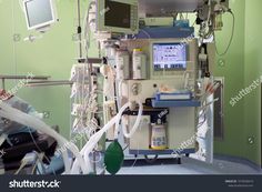 an operating room with monitors and medical equipment