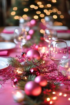 the table is set for christmas dinner with pink decorations