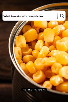 a tin filled with corn sitting on top of a wooden table next to an email box