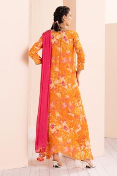 Saffron misty femme tunic with abstract print and thread and mirror embroidered neckline and sleeves. Comes with dhoti pant and a dupatta.
Components: 3
Pattern: Printed, Embroidered
Type Of Work: Abstract, Thread, Mirror
Neckline: V Neck
Sleeve Type: Three quarter
Fabric: Viscose crepe, Chiffon
Color: Orange
Other Details: 
Tasseled detailing on kurta and dupatta
Occasion: Sangeet - Aza Fashions Silk Maxi Length Palazzo Set For Eid, Silk Maxi Length Sets For Eid, Orange Silk Salwar Kameez With Traditional Drape, Silk Maxi Palazzo Set For Diwali, Silk Palazzo Set For Diwali, Maxi Length, Silk Maxi Length Palazzo Set For Diwali, Bollywood Style Orange Silk Salwar Kameez, Bollywood Silk Maxi Length Sets, Bollywood Silk Maxi Sets