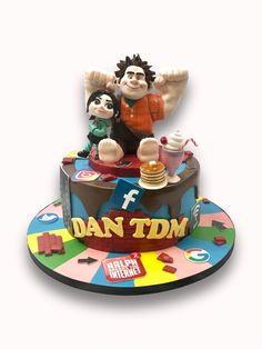 a cake that is shaped like a man and woman on top of it with the words dan