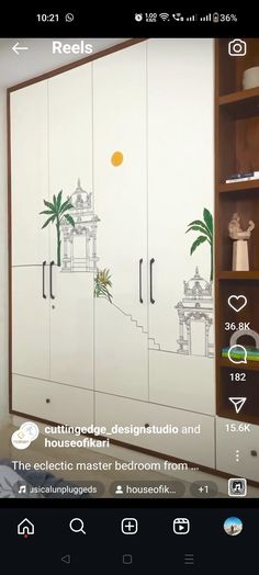 a room with white cupboards and drawings on the doors