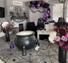 a living room decorated for halloween with balloons and flowers