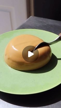 a donut on a plate with a spoon sticking out of it's center