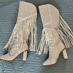 Gorgeous Knee High Boots! The Asire Boot By Jessica Simpson In White, Glittering In Clear Rhinestones, And The Bejeweled Fringe Gives A Fun And Ethereal Flare! Size 9.5! Worn Once For An Event In Nashville. They Are In Excellent Condition And Have Been Stored Upright With Pool Noodles Inserted To Keep Shape. Small Defects Are Pictured A Few Rhinestones Missing From The Back Of One Heel, And One Piece Of Fringe Has Been Pulled Off On The Inside Of One Boot. These Boots Will Turn Heads And They Ru Dressy Cowgirl Boots, White Embellished Boots With Pointed Toe, Leather Party Boots With Rhinestone Fringe, Party Leather Boots With Rhinestone Fringe, Glamorous White Embellished Boots, Party Boots With Rhinestone Fringe And Round Toe, White Embellished Boots With Round Toe, White Leather Boots With Rhinestones, White Rhinestone Boots With Round Toe