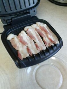 bacon is being cooked in an air fryer