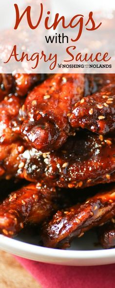 wings with angry sauce in a bowl on top of a wooden table and text overlay reads wings with angry sauce