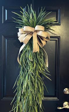 a door with a wreath and bow hanging on it