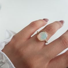 RING DETAILS: ✪Design: Gold ring ✪Gemstone: Natural welo opal, moissanite diamonds ✪Gemstone shape: Oval ✪Gemstone size: 10X12 mm ✪Setting type: Prong ✪Metal type: 14k solid yellow gold ✪Metal finish: Smooth shiny Choose your ring size from drop down menu and if you need any other preferred ring size please contact us. QUALITY OF MATERIALS: Metal: Most of our jewelry at JewelryMansion is made with precious metals like gold and silver. These metals are 100% non-allergic to our skin. Gemstone: All 14k Yellow Gold Opal Ring Birthstone, Yellow Gold Oval Cabochon Rings With Birthstone, Gold Opal Jewelry With Prong Setting, Oval Opal Rings With Bezel Setting, Gold Oval Opal Birthstone Ring, Yellow Gold Oval Opal Ring, Oval Opal Jewelry With Bezel Setting, Gold Opal Ring With Prong Setting As Gift, 14k Gold Rings With Bezel Set Oval Cabochon