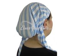 a woman wearing a blue and white striped head scarf with a knot at the top