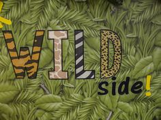 the words wild side are painted on green leaves