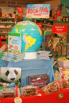 there is a display in the store with books and toys on it's table