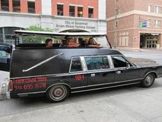 a black limousine with people in it parked on the street