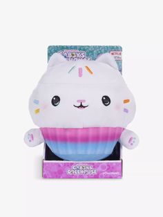 a white stuffed animal with sprinkles on it's head in a box