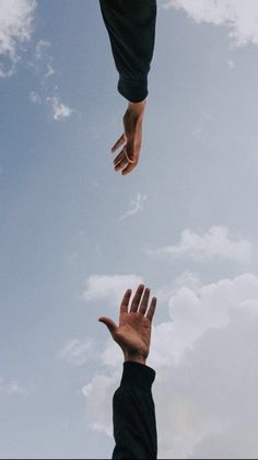 two hands reaching up into the sky