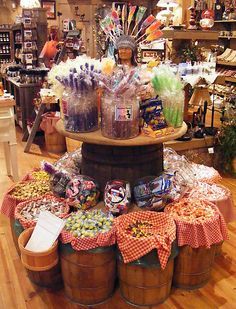 a display in a store filled with lots of candy and candies on buckets