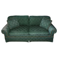 a green couch sitting on top of a white floor