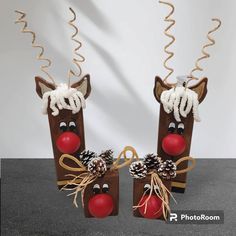 two christmas decorations made to look like reindeers with pine cones on their nose and noses