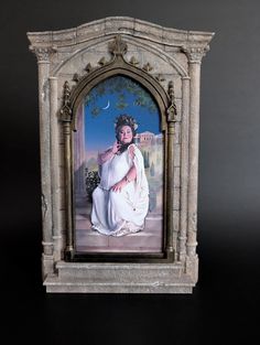 a miniature painting of a woman in white sitting on a stone bench with a moon above her head