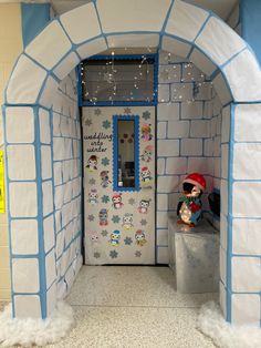 an entrance to a winter themed room with snowflakes on the walls and decorations