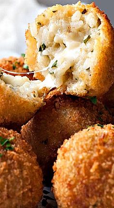 a close up of some food on a plate with broccoli and cheese in it