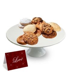 a white plate topped with cookies next to a red card