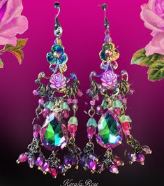 "This pair of Handmade Chandelier Earrings is made with Vitrial Rose teardrop jewels and sparkly Blue helix crystal beads.  Fuchsia AB Czech glass roses and hand-wrapped bead charms add loads of colorful detail. They're a delicate fantasy design with a pretty sparkle! The teardrop jewels are a vibrant Mint Green with Magenta edging.  Pierced with french wires  clip-ons or posts, just select from the pull-down menu.  Choose from the long or short version.  The short is seen in the first 2 images. Jeweled Dangle Chandelier Earrings As Gift, Jeweled Dangle Chandelier Earrings, Crystal Dangle Chandelier Earrings For Celebration, Crystal Chandelier Dangle Earrings For Celebration, Bohemian Crystal Chandelier Drop Earrings, Bohemian Crystal Chandelier Earrings, Pink Jeweled Dangle Chandelier Earrings, Jeweled Chandelier Dangle Earrings For Celebration, Bohemian Jeweled Dangle Chandelier Earrings