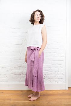 "SIZING AND FIT The skirt is true to size - we recommend choosing the size you usually wear. Before placing on order check our size chart below. Model in picture is 167cm ⅼ 5'6\" height and is wearing size M. Approximate length of the skirt for size M measured at the side seam is ±80cm ⅼ ±31.5\" SIZE XS Bust: around 33.5\" / 85cm Waist: around 26\" / 66cm Hips: around 36\" / 91 cm SIZE S Bust: around 35.5\" / 90 cm Waist: around 28\"/ 71 cm Hips: around 38\"/ 97 cm SIZE M Bust: around 37.5\" / 9 Summer Wide Leg Linen Wrap Skirt, Summer Linen Wide Leg Wrap Skirt, Flared Linen Wrap Skirt For Summer, Asymmetrical Linen Skirt With Lining, Linen Asymmetrical Skirt With Lining, Summer Flared Linen Wrap Skirt, Casual Linen Long Wrap Skirt, Summer Linen Flared Wrap Skirt, Chic Asymmetrical Linen Wrap Skirt