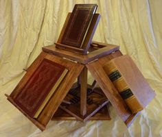 a stack of books sitting on top of each other in front of a white sheet