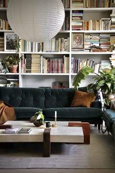 a living room filled with lots of books and furniture