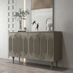 an art deco sideboard with two vases on it and a mirror in the background