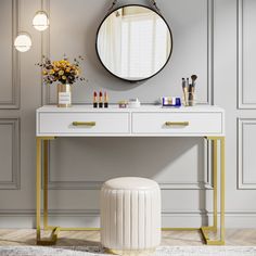 a white dressing table with gold legs and a round mirror on the wall above it