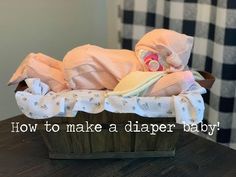 a baby's diaper in a basket with the words how to make a diaper baby