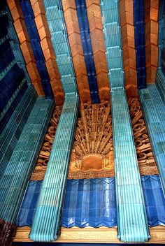 the inside of a building with blue and gold columns