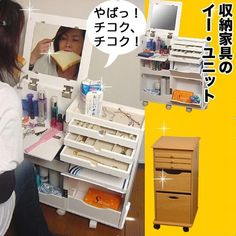 a woman sitting in front of a mirror brushing her teeth