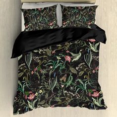 an image of a bed with black comforter and pillow cases on top of it