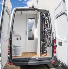 an open van door with bikes in the back