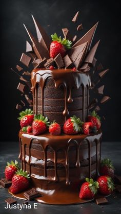 a chocolate cake with strawberries on top and chocolate drizzled over it