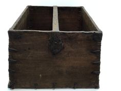 an old wooden box sitting on top of a white surface with rivets in it