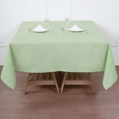 the table is set with two empty glasses and plates on it, ready to be served